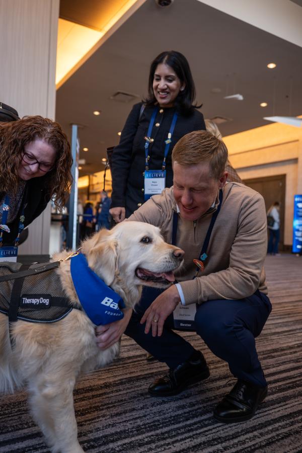 Baxter leaders petting Pet Partners therapy dog