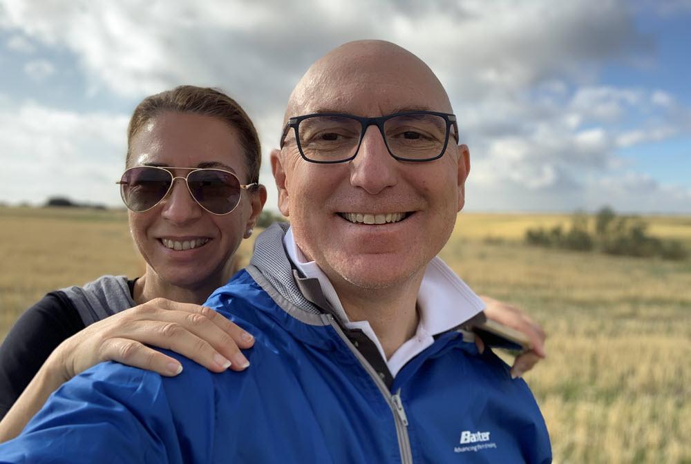 Baxter leader and his wife standing outside on a cloudy afternoon