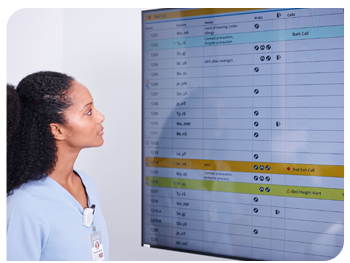a nurse views a monitor displaying patient data